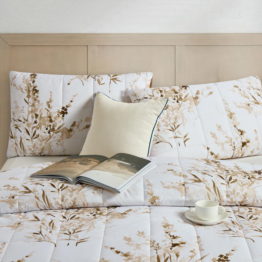 Close-up of golden floral quilted design and stitching.