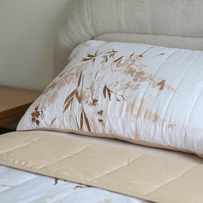 Close-up of golden floral quilted design and stitching.