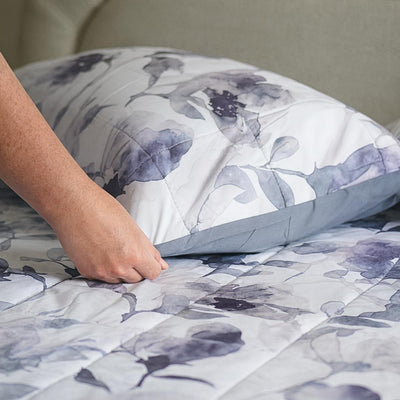 Morgan and Reid Midnight Orchid Cloudy Coverlet Set - Close-up of watercolour floral quilted fabric in grey and indigo.