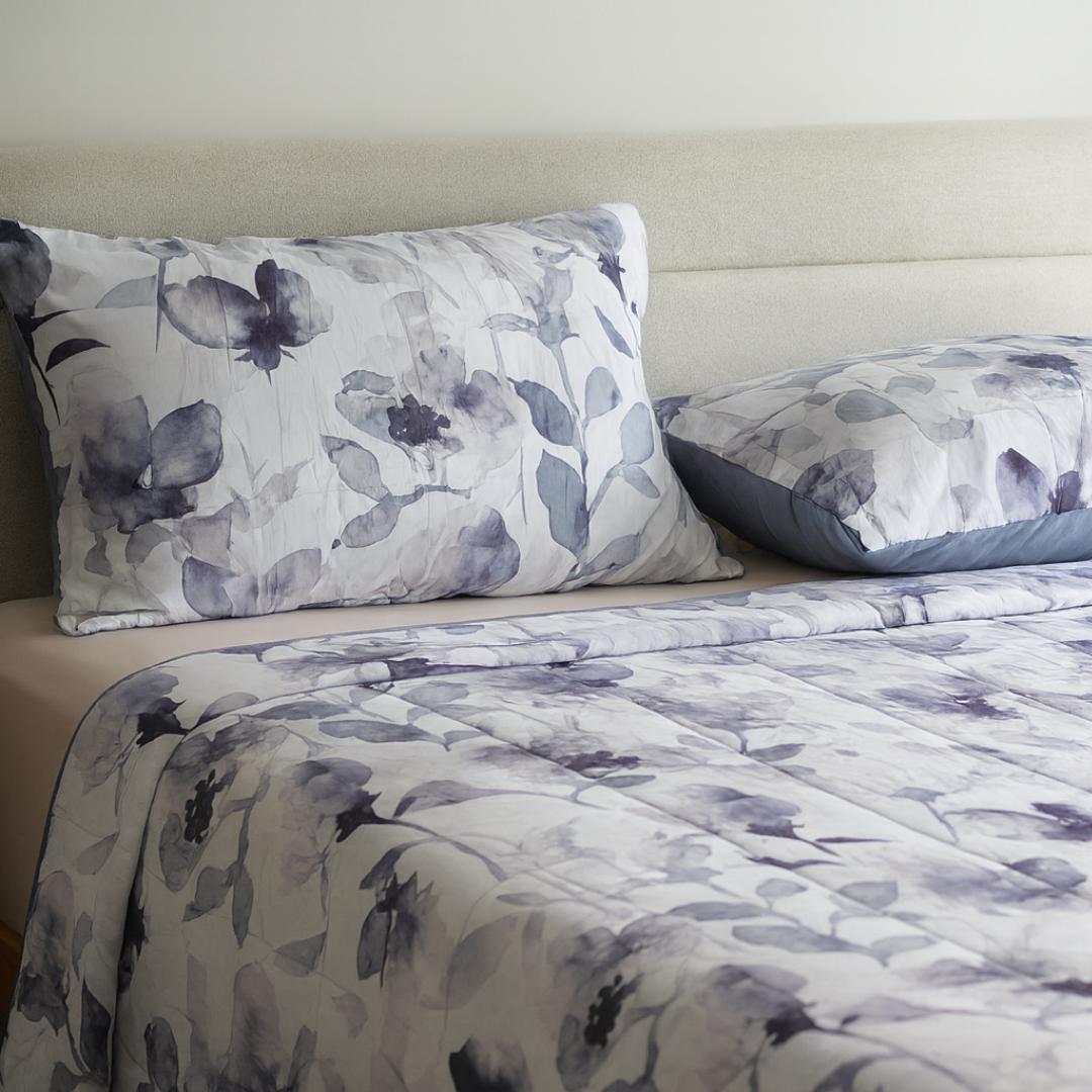 Morgan and Reid Midnight Orchid Cloudy Coverlet Set - Close-up of watercolour floral quilted fabric in grey and indigo.