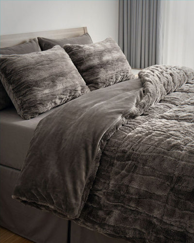 Morgan and Reid Deep Cocoa Snuggle Fleece Rabbit Fur European Pillowcase Pair on bed with coordinating bedding