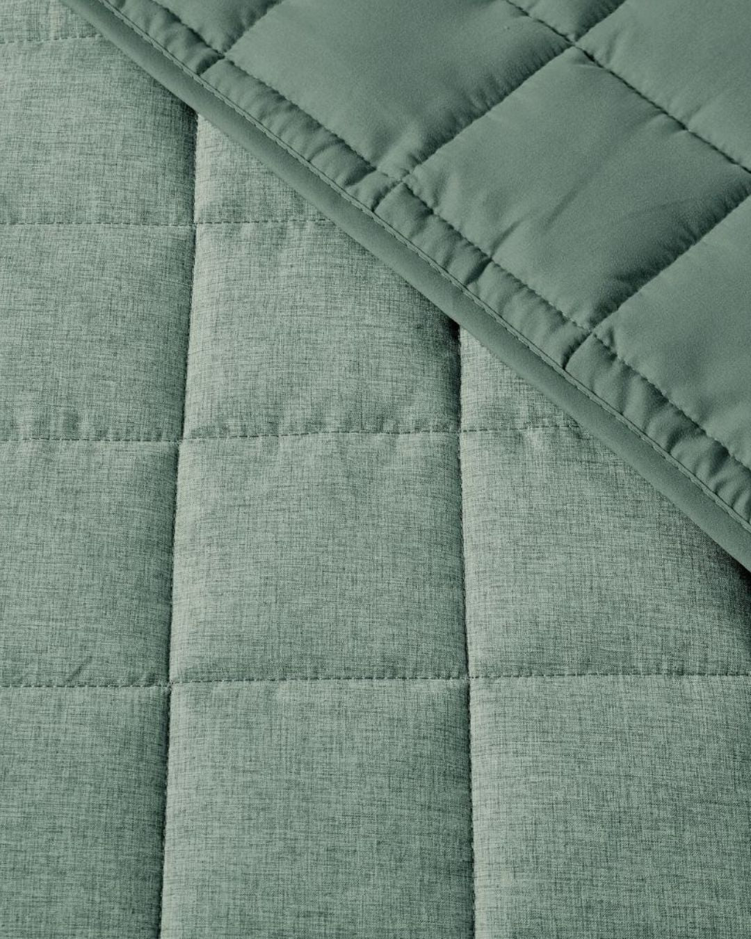 Close-up of a green quilted fabric with a textured pattern