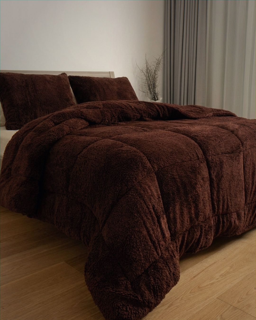 Brown plush comforter on a bed in a bedroom setting