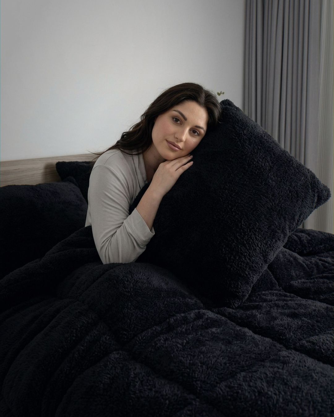 Morgan and Reid Black Snuggle Fleece Pillowcase Pair on bed with coordinating bedding