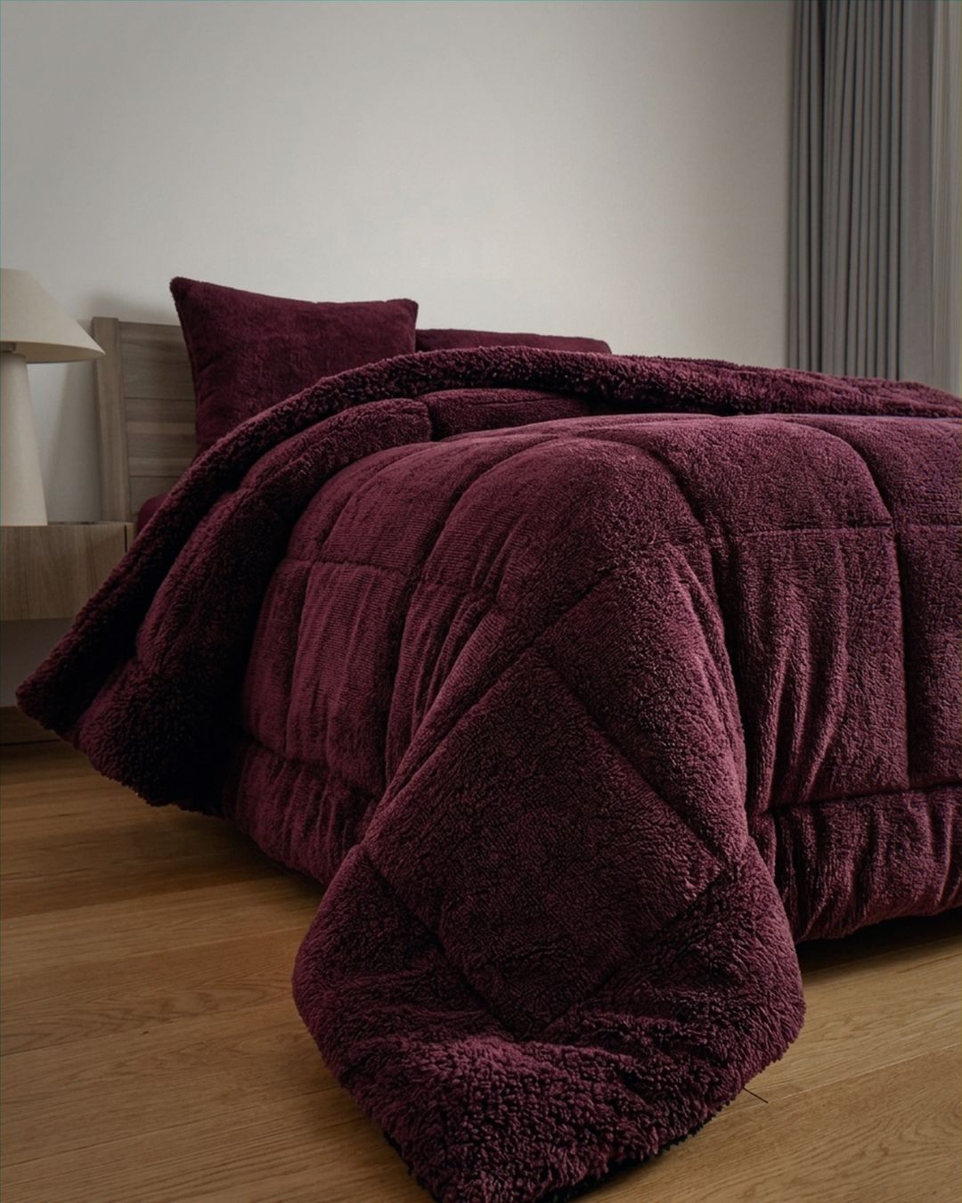 Overhead view of the Morgan and Reid Burgundy Black Snuggle Fleece Comforter Set on a made bed