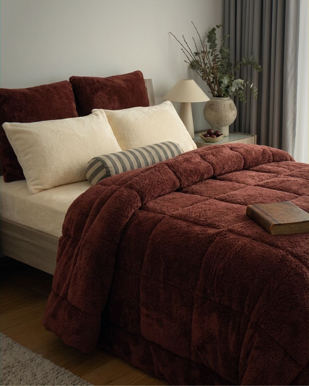 Bed with brown comforter and pillows in a bedroom setting