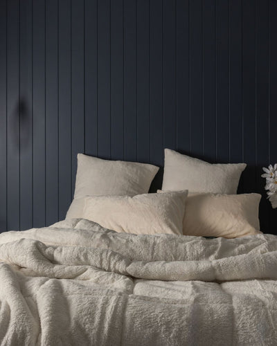 Morgan and Reid Ivory Snuggle Fleece Comforter Set on a bed with matching pillowcases