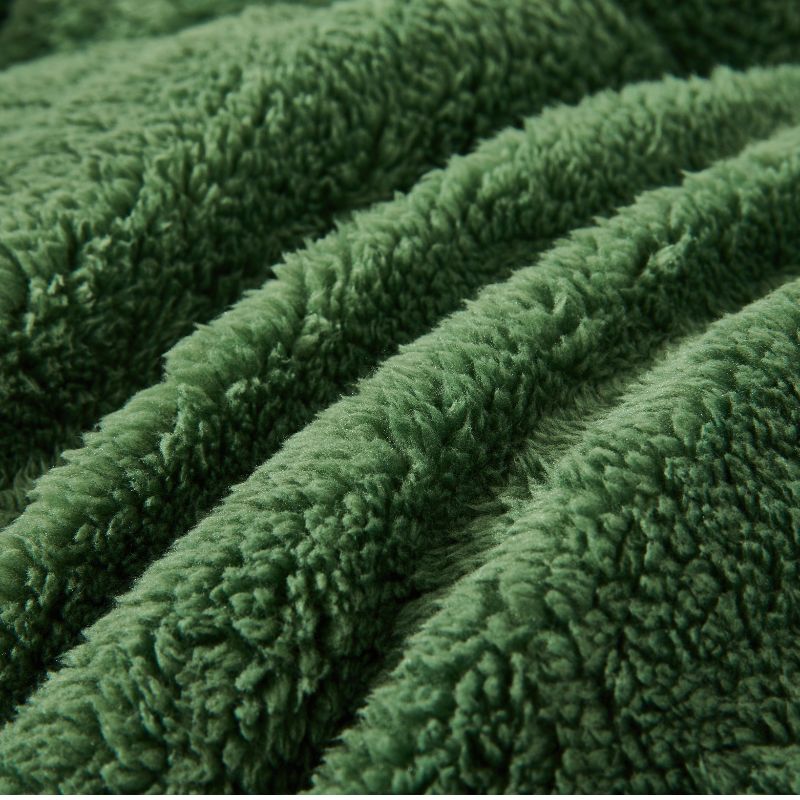 The Morgan and Reid Jungle Snuggle Fleece Pillowcase Pair features a rectangular green design with plush texture and slightly rounded corners, crafted from soft snuggle fleece, shown on a plain white background.