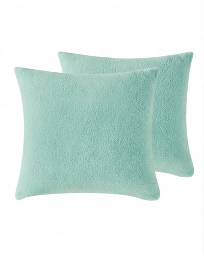 Morgan and Reid Mint Snuggle Fleece European Pillowcase Pair on a styled bed with matching comforter
