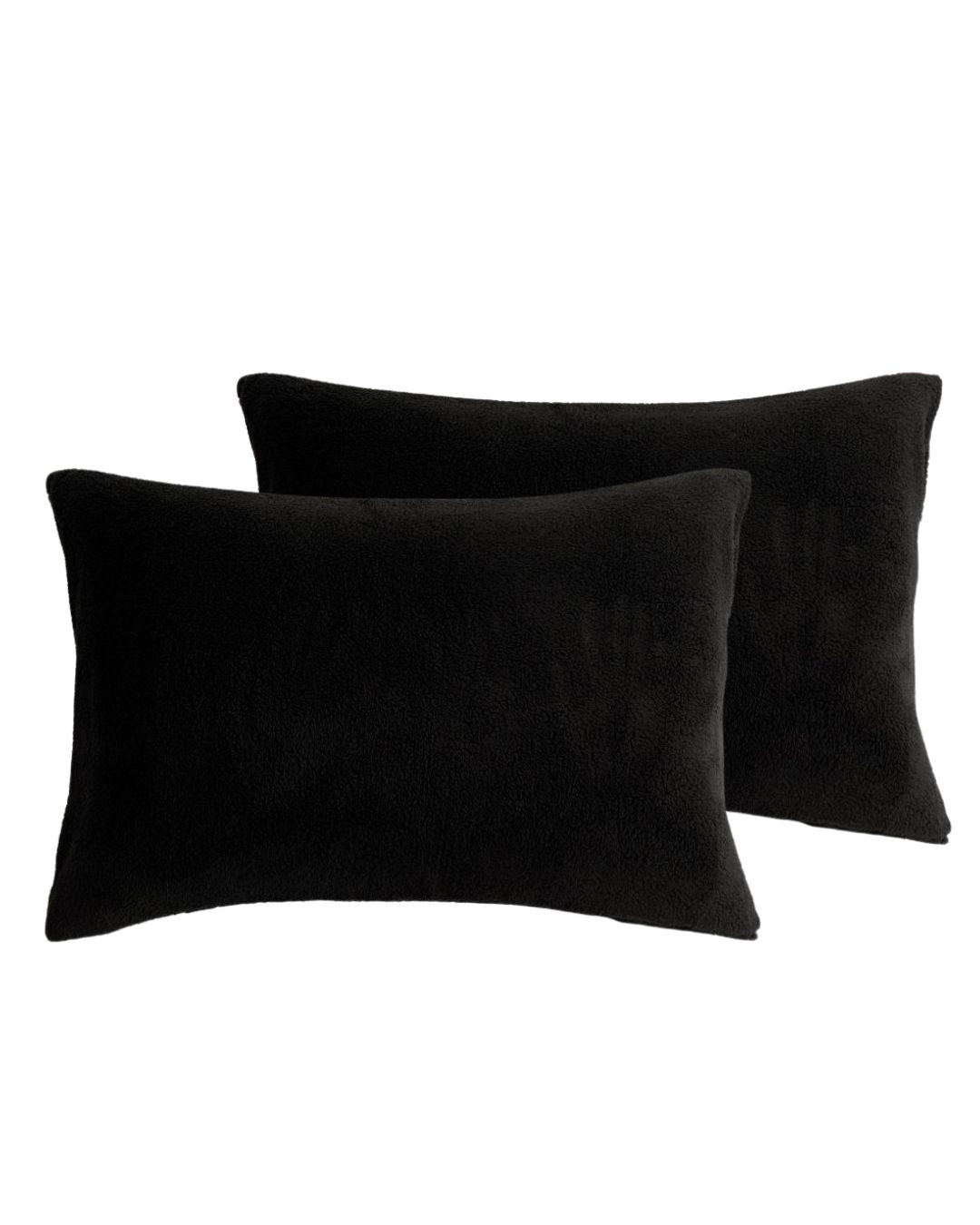 Morgan and Reid Black Snuggle Fleece Pillowcase Pair on a styled bed with matching comforter