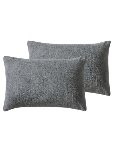 Morgan and Reid Charcoal Snuggle Fleece Pillowcase Pair on a styled bed with matching comforter