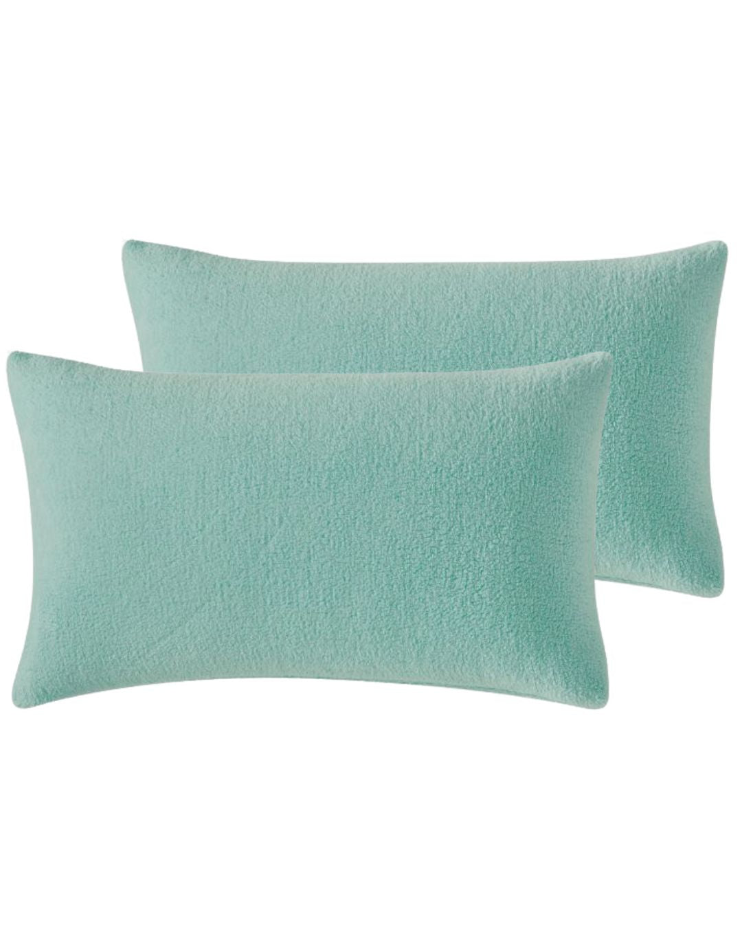 Morgan and Reid Mint Snuggle Fleece Pillowcase Pair on a styled bed with matching comforter