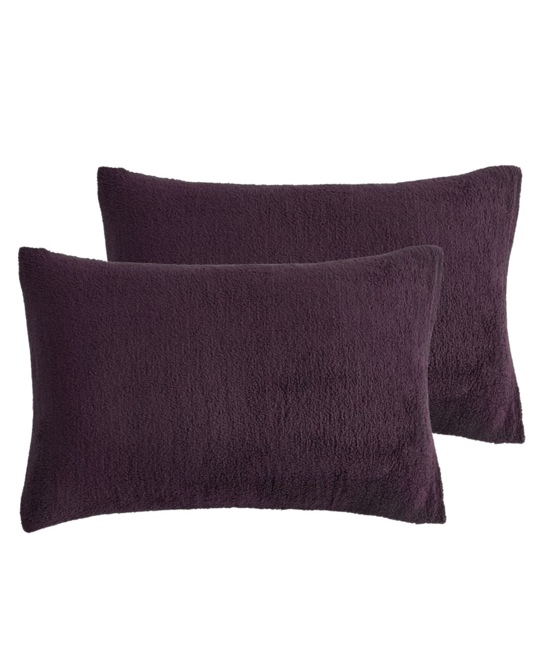 Morgan and Reid Plum Snuggle Fleece Pillowcase Pair on a styled bed with matching comforter