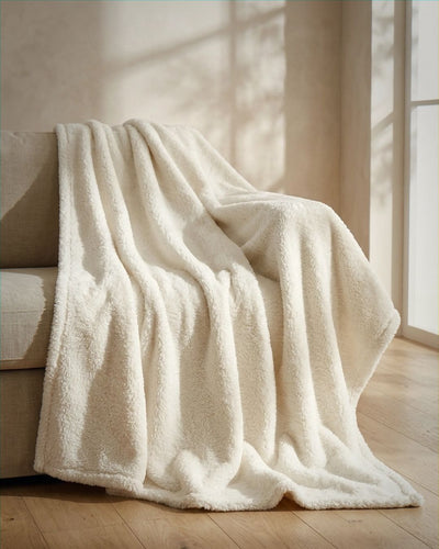 White blanket draped over a chair in a softly lit room
