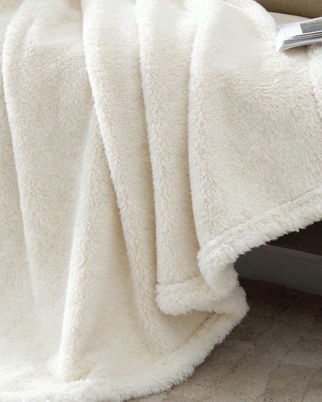 Close-up of a white fluffy blanket on a surface