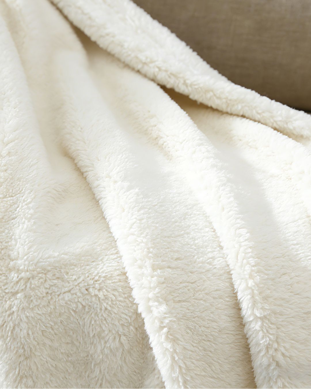 Close-up of a fluffy white blanket with soft texture