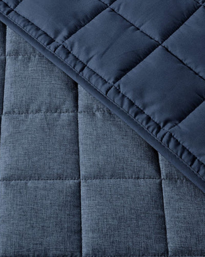 Close-up of a blue quilted fabric with a textured surface