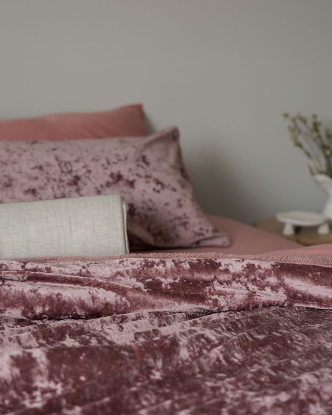 Detail shot of the Morgan and Reid Shell Pink Velvet Crushed Snuggle Fleece Pillowcase Pair on pillows