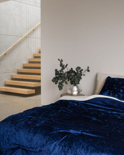 Morgan and Reid Navy Velvet Crushed Snuggle Fleece Comforter Set on a bed with matching pillowcases