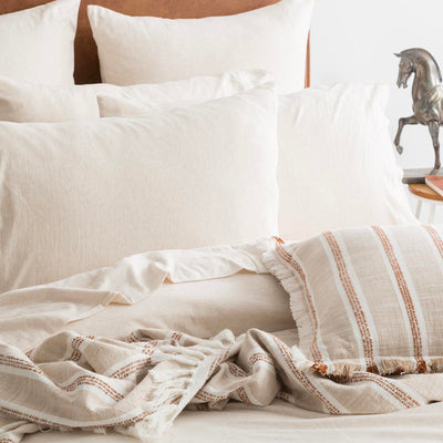 Styled bed featuring Renee Taylor Oatmeal European Pillowcase with matching jersey bedding.