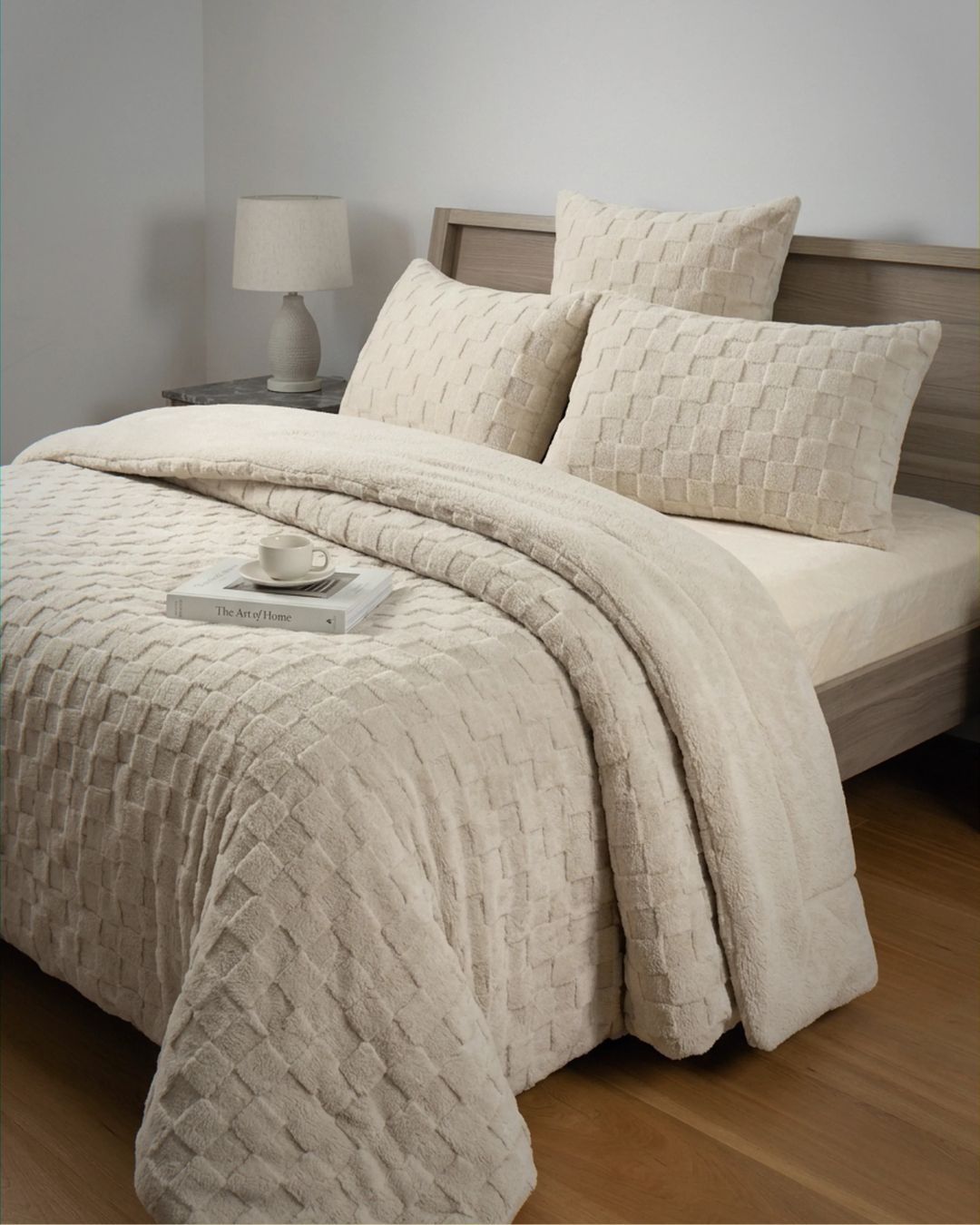Sand checkered snuggle fleece comforter set styled on bed with matching pillows and cozy neutral bedroom decor