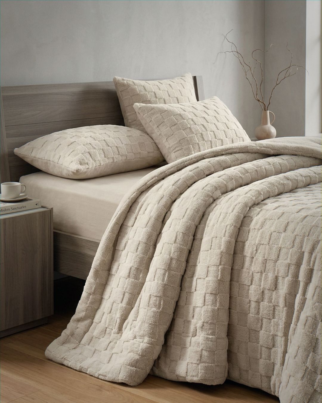 Sand checkered snuggle fleece comforter set styled on bed with matching pillowcases in neutral bedroom setting.