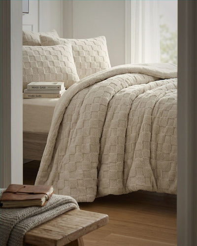 Sand checkered snuggle fleece comforter set styled on bed with matching pillows in neutral bedroom setting.